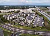 Thumbnail 21 of 60 - Aerial view of residential buildings with office complex at Avli At Crosstown Center Apartments, TAMPA, FL 33619