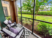 Thumbnail 12 of 46 - Patio with chairs and a screened in patio