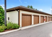 Thumbnail 16 of 46 - a row of garages with brown doors