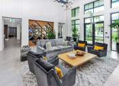 Thumbnail 19 of 46 - a clubhouse living room filled with furniture and a large window
