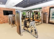 Thumbnail 36 of 46 - a spacious fitness room with cardio machines and weights