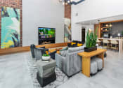 Thumbnail 43 of 46 - a clubhouse living room filled with furniture and a flat screen tv