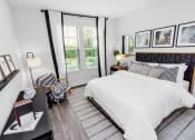 Thumbnail 7 of 46 - a bedroom with white bedding and black and white decor