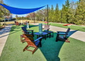 Thumbnail 10 of 54 - Riverstone outdoor game area with seating