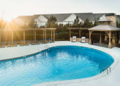 Thumbnail 4 of 54 - a swimming pool with chairs and a house in the background
