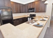 Thumbnail 50 of 54 - a kitchen with a large countertops and black appliances