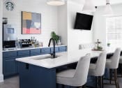 Thumbnail 53 of 54 - a kitchen with blue cabinets and an island with a sink and chairs