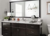 Thumbnail 51 of 54 - A bathroom vanity with a mirror above it.