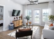 Thumbnail 3 of 78 - a living room with a couch and a chair and a ceiling fan