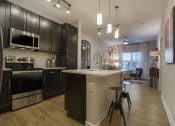 Thumbnail 50 of 78 - Fitted Kitchen With Island Dining at Pointe at Prosperity Village Apartments for Rent in North Carolina
