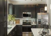 Thumbnail 51 of 78 - Updated Kitchen With Black Appliances at Pointe at Prosperity Village Apartment Rentals in Charlotte
