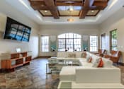Thumbnail 1 of 30 - a large living room with a white couch and a television
