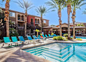 Thumbnail 17 of 30 - a swimming pool with blue chairs and palm trees