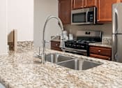 Thumbnail 4 of 30 - a kitchen with granite counter tops and a sink