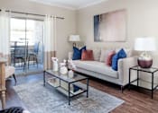 Thumbnail 6 of 30 - a living room with a couch and a glass coffee table