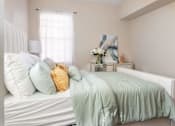 Thumbnail 9 of 30 - a bedroom with a bed with blue and yellow pillows