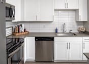 Thumbnail 4 of 34 - White kitchen at Pointe at Lake Crabtree Apartments, Morrisville, 27560