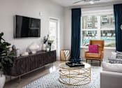 Thumbnail 6 of 34 - Living room with large window at Pointe at Lake Crabtree Apartments, Morrisville, 27560