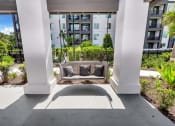Thumbnail 16 of 32 - a seating area on the patio of an apartment building
