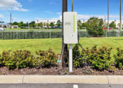 Thumbnail 17 of 32 - a power outlet on the side of a road with a green grassy field in the background