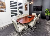 Thumbnail 25 of 32 - a conference room with a table and chairs