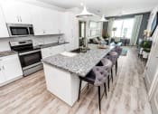 Thumbnail 3 of 32 - a kitchen with a center island next to a stove top oven