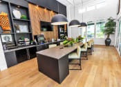 Thumbnail 7 of 32 - a large kitchen with a long counter and chairs