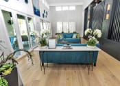 Thumbnail 8 of 32 - a living room with a blue couch and white flowers on the table