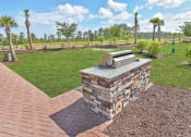 Thumbnail 28 of 37 - a backyard with a bbq and a grassy area