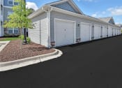 Thumbnail 29 of 37 - a row of white garage doors in front of a house
