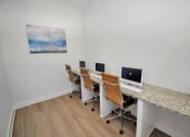 Thumbnail 37 of 37 - a desk with three computers on it and a painting on the wall