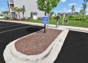 Thumbnail 31 of 37 - a parking lot with a blue and white sign in the middle of it