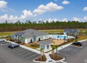 Thumbnail 35 of 37 - an aerial view of a house and a swimming pool in a parking lot