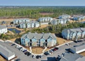 Thumbnail 34 of 37 - an aerial view of an apartment complex with a parking lot