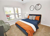 Thumbnail 4 of 37 - a bedroom with a bed and two windows