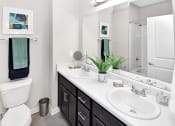Thumbnail 5 of 37 - a bathroom with a toilet sink and mirror