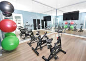 Thumbnail 19 of 37 - a room filled with lots of exercise equipment and a large window