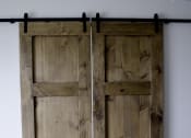 Thumbnail 2 of 10 - an image of a pair of wooden doors on a black rail