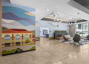 Thumbnail 7 of 36 - A large mural of a train on a wall in a waiting area.