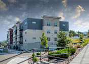 Thumbnail 15 of 20 - a rendering of an apartment building with a cloudy sky in the background