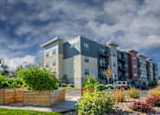 Thumbnail 1 of 20 - a rendering of an apartment building with a cloudy sky in the background