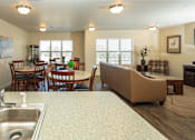 Thumbnail 10 of 20 - a kitchen with a sink and a table with chairs