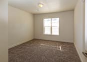 Thumbnail 18 of 20 - a bedroom with a carpeted floor and a window