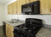 Thumbnail 8 of 10 - a kitchen with a stove microwave and sink