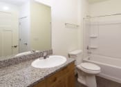 Thumbnail 4 of 10 - a bathroom with a sink toilet and bathtub