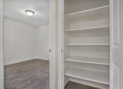 Thumbnail 13 of 14 - Empty room with a white door and shelves.