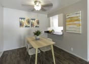 Thumbnail 19 of 32 - a dining room with a table and chairs and a ceiling fan