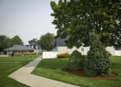 Thumbnail 7 of 32 - a yard with two shrubs and a tree in front of a house