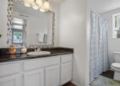 Thumbnail 30 of 32 - a bathroom with a sink toilet and a shower
