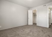 Thumbnail 29 of 32 - a bedroom with a carpeted floor and a door to a closet